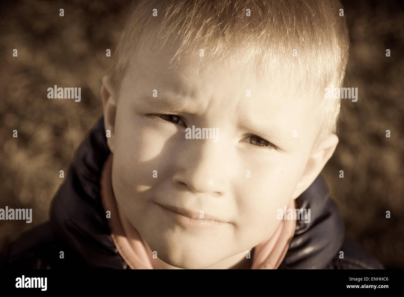 Sad upset tired worried unhappy little child (boy) close up horizontal, expressive eyes Stock Photo