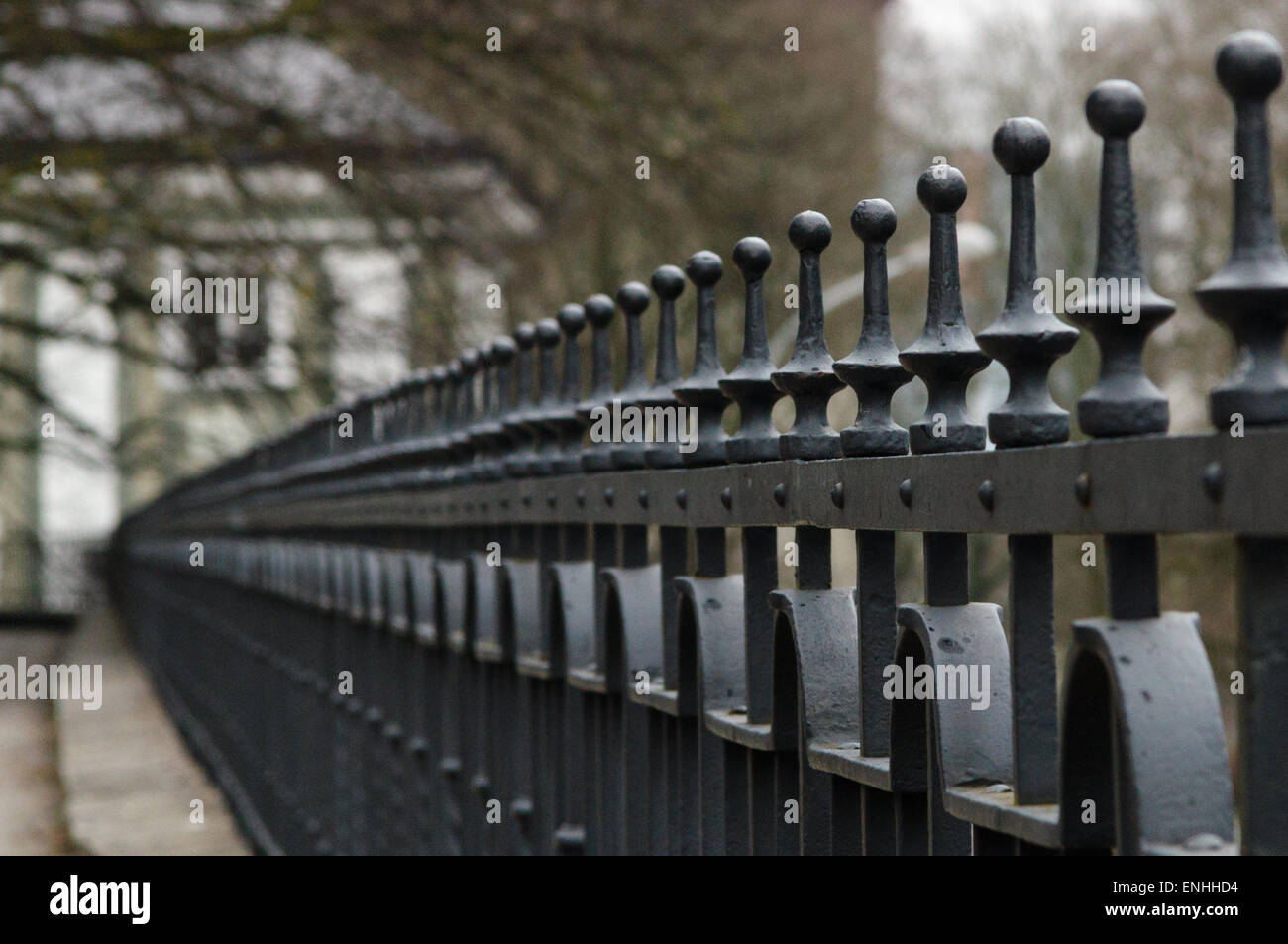 Line of wrought-iron fence spikes Stock Photo