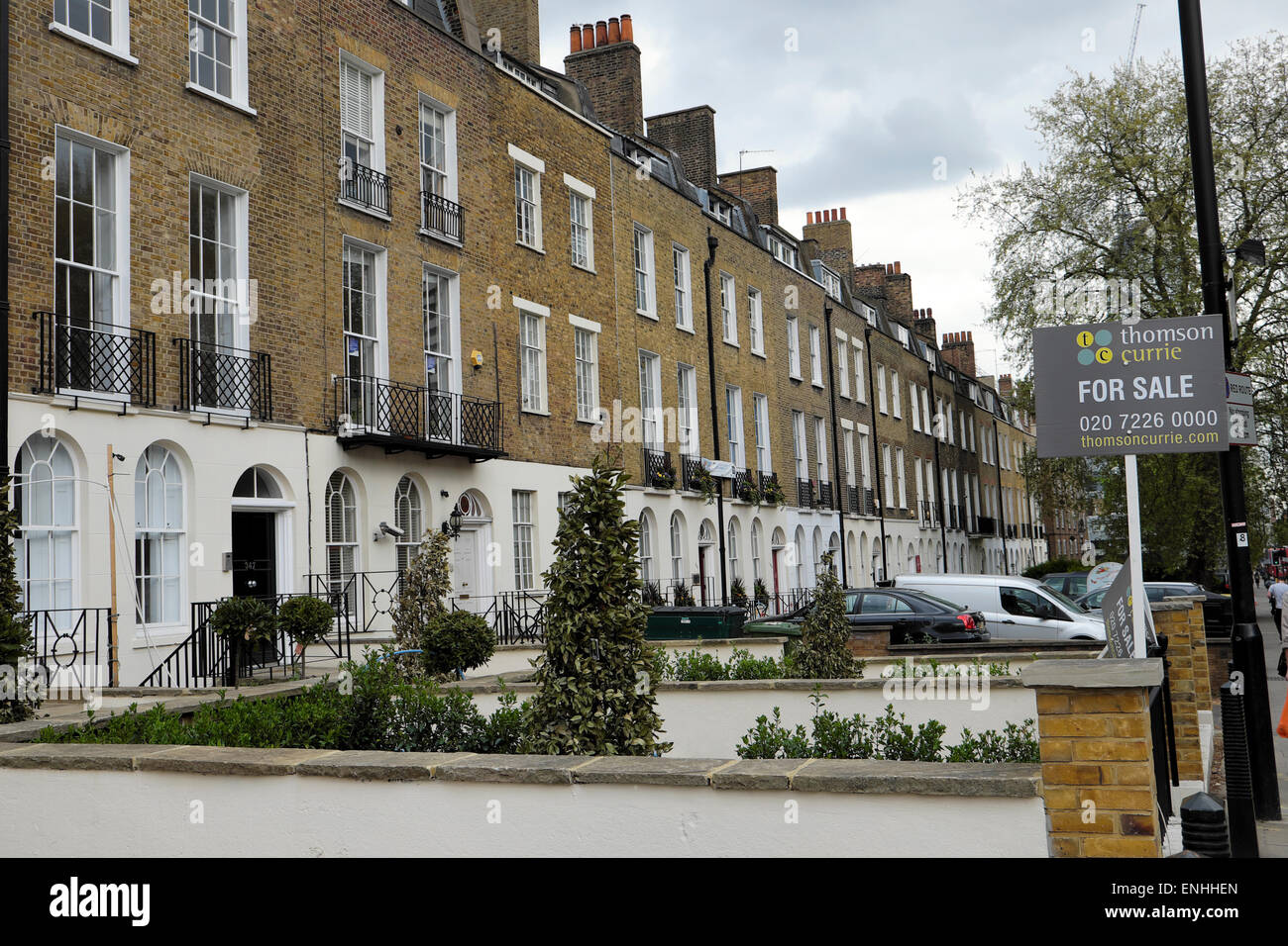 Row of refurbished Victorian terraced houses flats for sale sign on