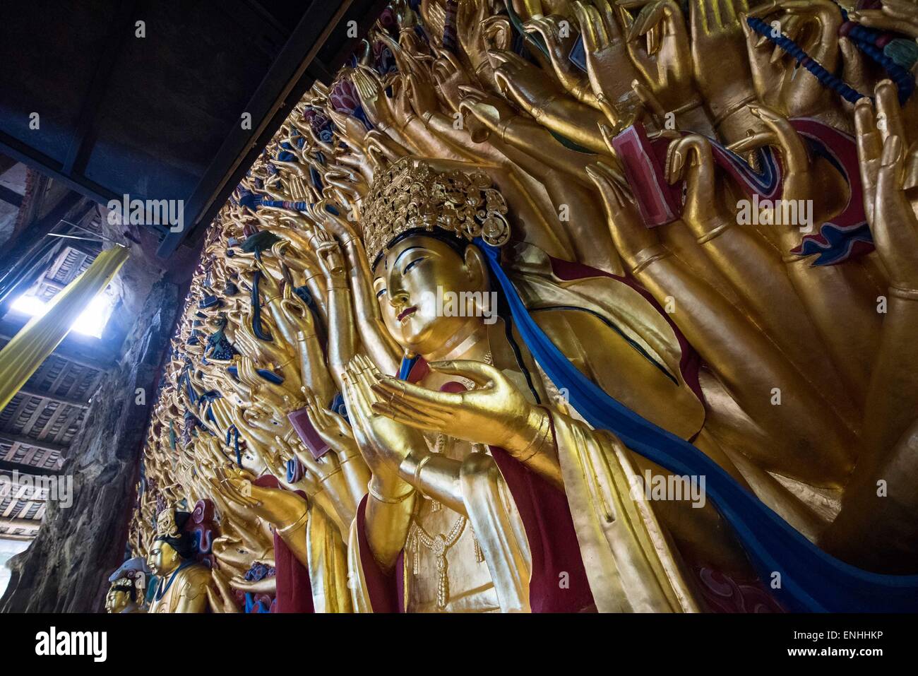 (150506) -- CHONGQING, May 6, 2015 (Xinhua) -- Photo taken on May 5, 2015 shows the restored statue of Qianshou Guanyin (bodhisattva with a thousand hands) on Mount Baoding in Dazu District, southwest China's Chongqing. The statue with gold foil, carved in the cave with 7.7 meters high and 12.5 meters wide, could date back to Southern Song Dynasty (1127 to 1279). The restoration work has been completed and accepted by experts from administration of cultural heritage, colleges and academies on May 6. The statue will be reopened to public on June 13, which is also the Chinese 'Cultural Heritage Stock Photo