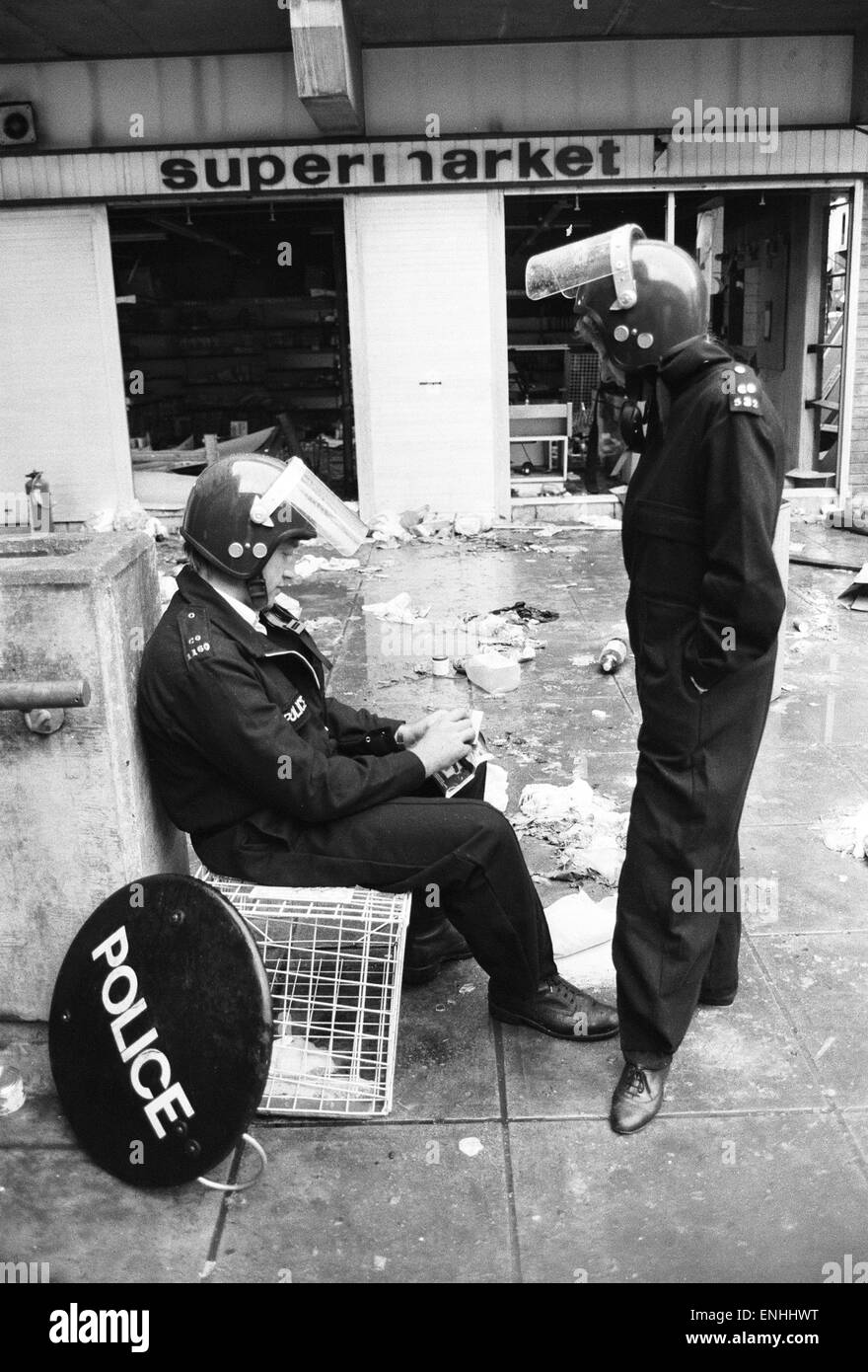 Aftermath of the riots which broke out in the Broadwater Farm estate in Tottenham, North London. The riot started the day after local resident Cynthia Jarrett died during a disturbance while police searched her home. Picture shows riot police taking a res Stock Photo