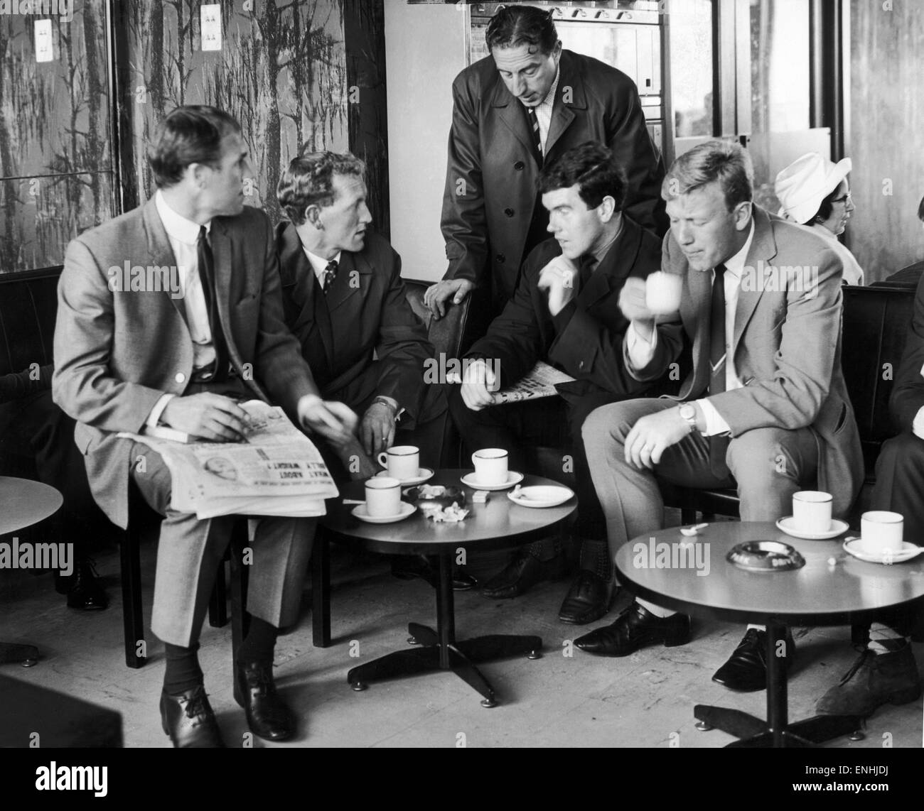 Everton players enjoy a cup of tea at Speke Airport before flying out to Norway from Liverpool. Pictured left to right seated: Ray Wilson, Sandy Brown, Alex Scott, Jimmy Gabriel with manager Harry Catterick standing behind. 8th August 1965. Stock Photo