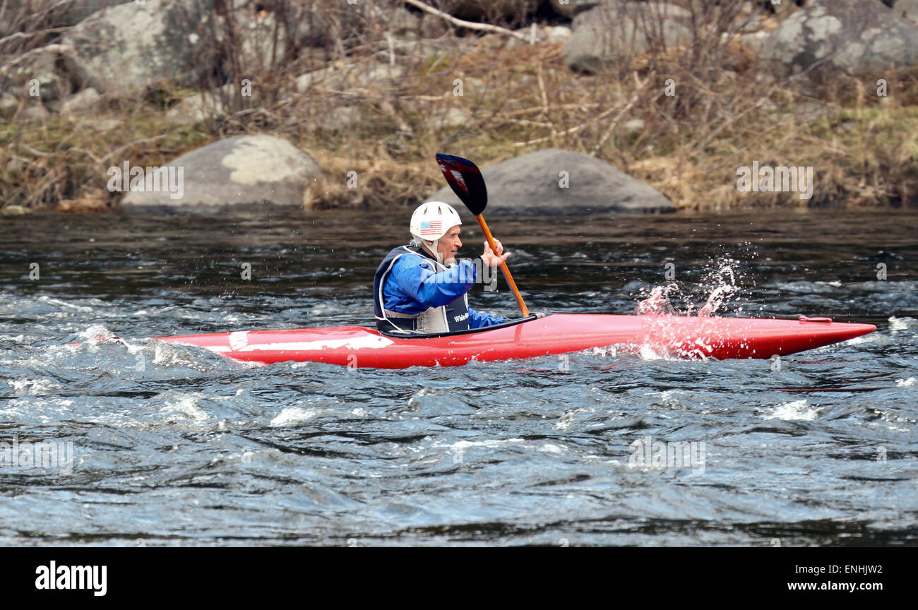 Senior man in a kayak paddling the rapids on the Hudson River in the Adirondack State Park Adirondacks. Stock Photo