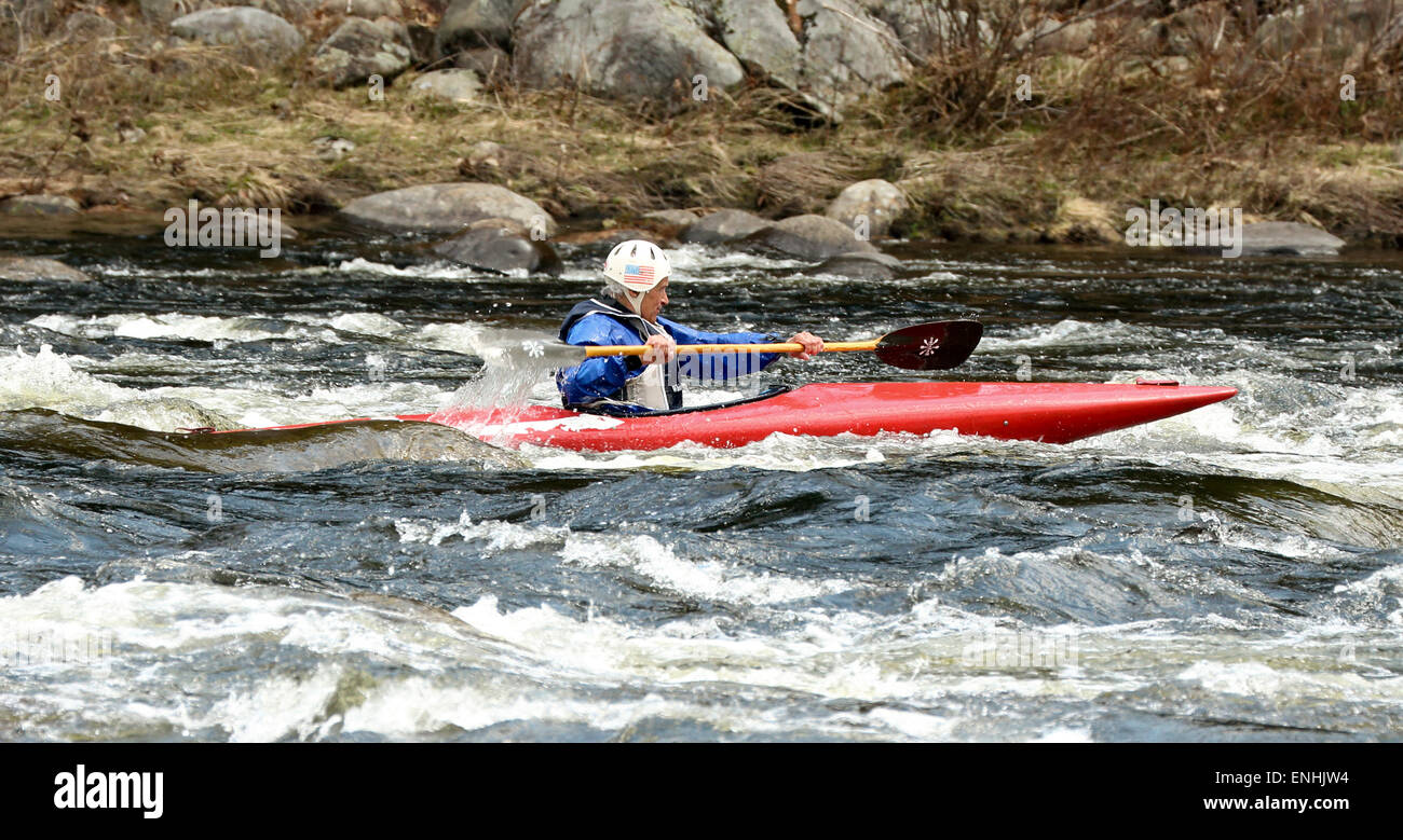 Senior man in a kayak paddling the rapids on the Hudson River in the Adirondack State Park Adirondacks. Stock Photo