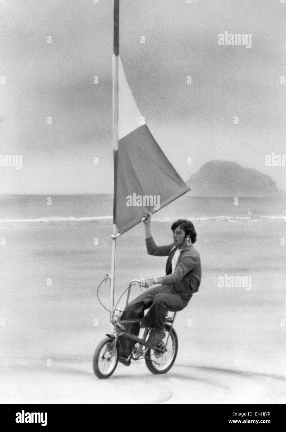 Cycles: This is 20 year old David Healey and his Sailbike. David, who is the grandson of car designer, Donald Healey, has produced his sail device, which will fit onto virtually any bike, at a cost of around £50. July 1977. Stock Photo