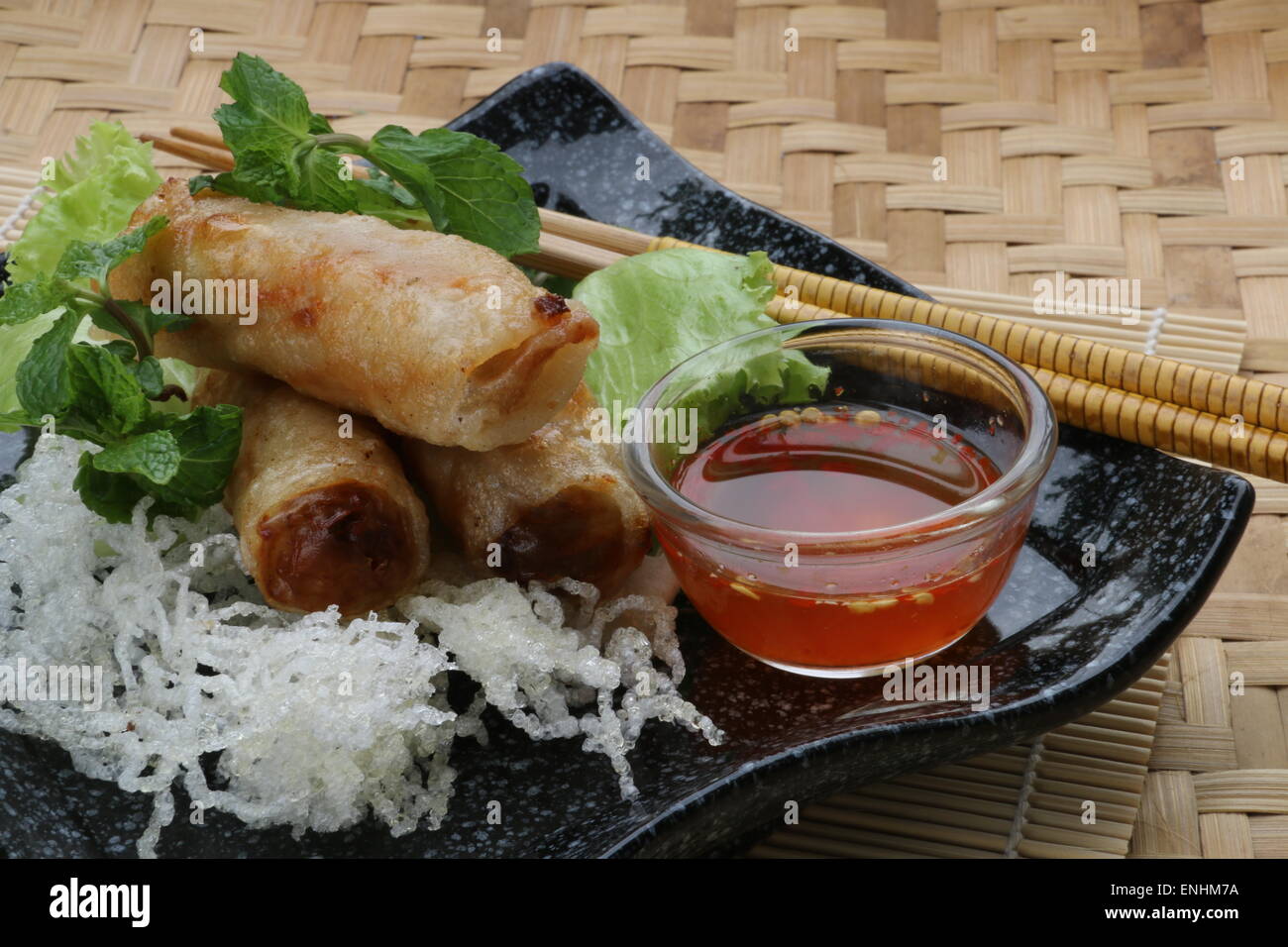 Cha Gio, Vietnamese fried spring rolls, served with chili dipping sauce Stock Photo