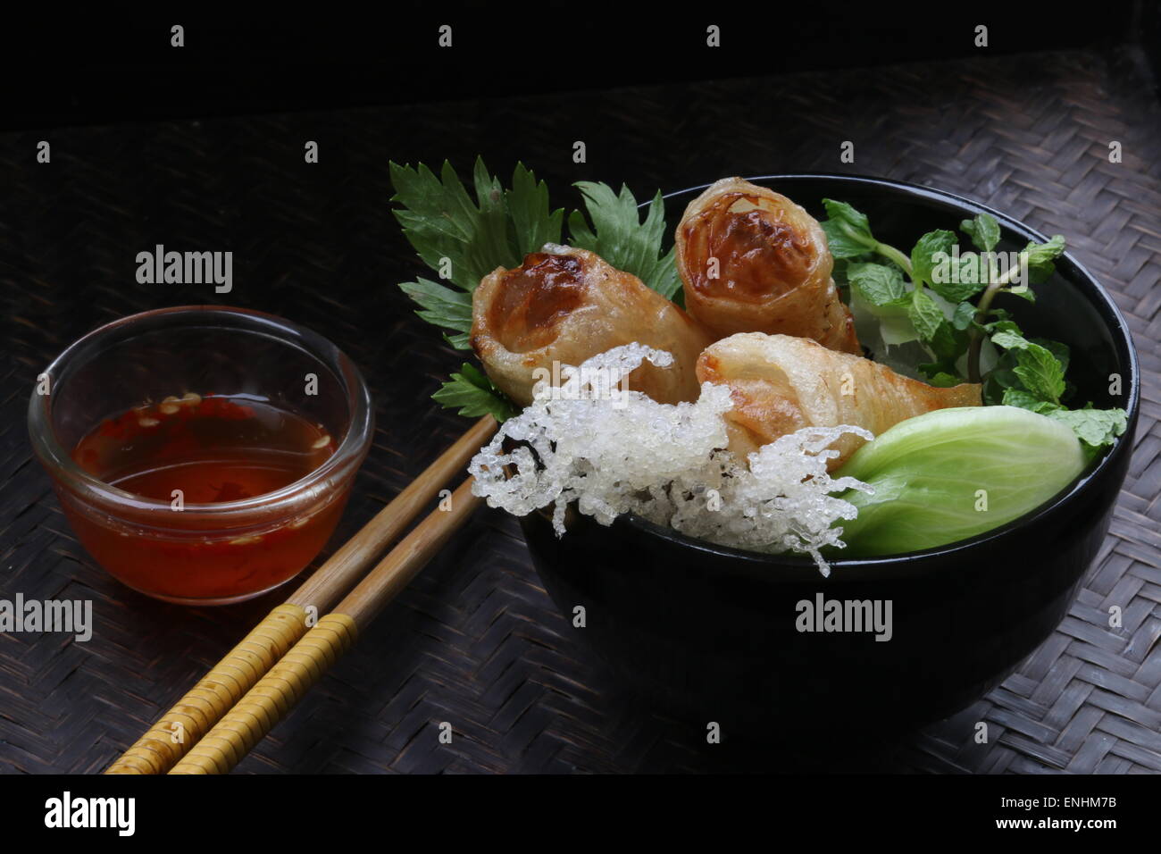Cha Gio, Vietnamese fried spring rolls, served with chili dipping sauce Stock Photo