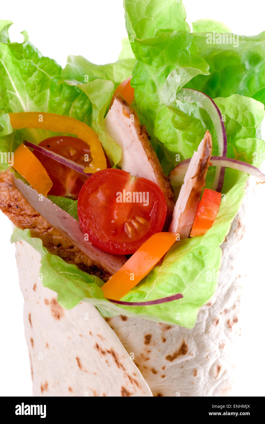Tortilla wrap with vegetables and meat. Stock Photo