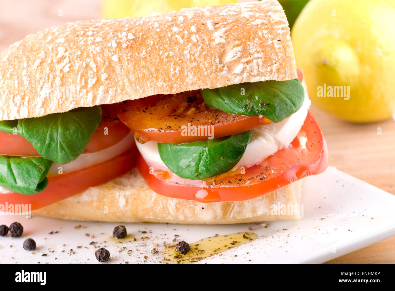 Ciabatta with mozzarella, tomato, basil, pepper and olive oil. Stock Photo