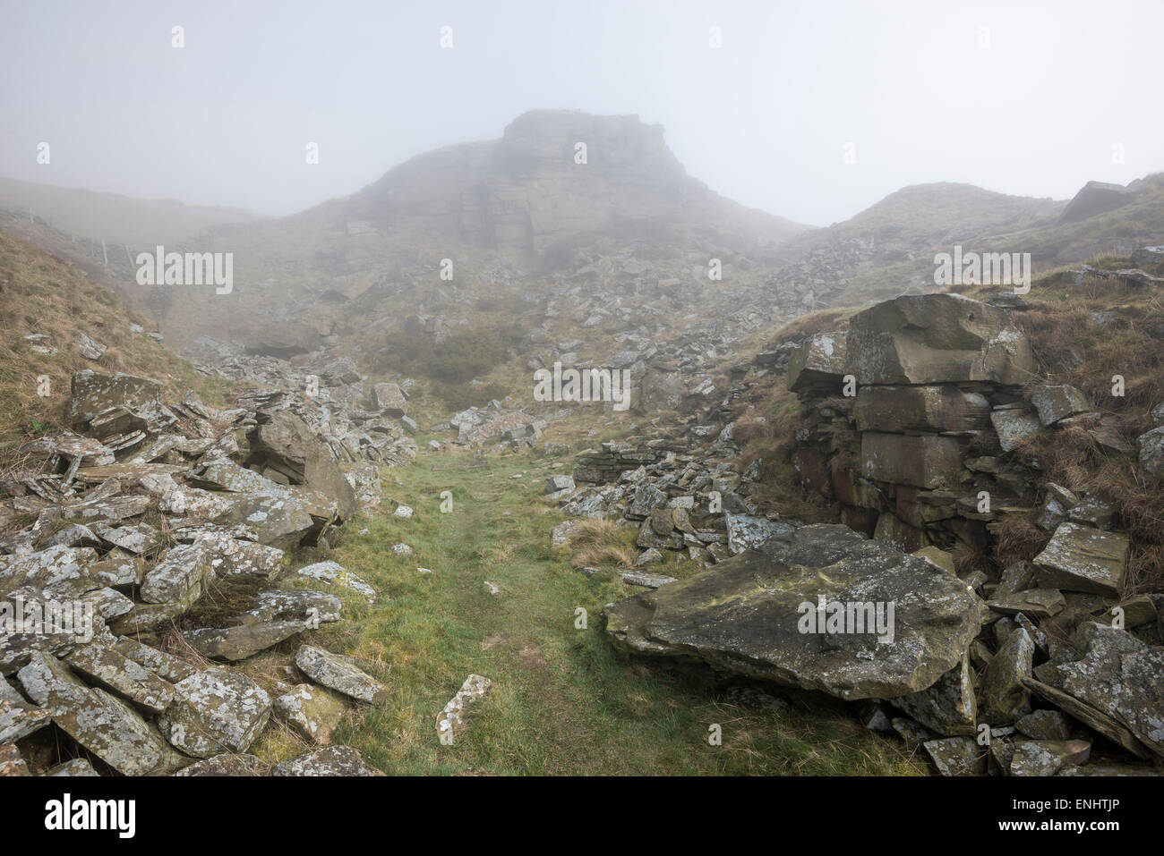 Remains of a disused quarry on Cracken edge near Chinley in Derbyshire. A foggy spring morning. Stock Photo