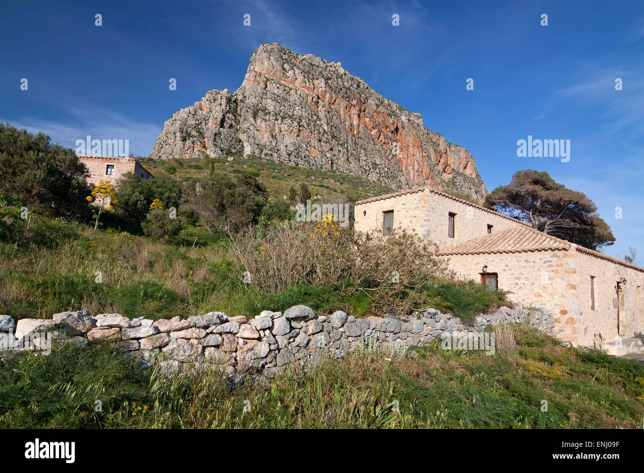 A view to the rock of Monemvasia and an old building, Greece Stock Photo