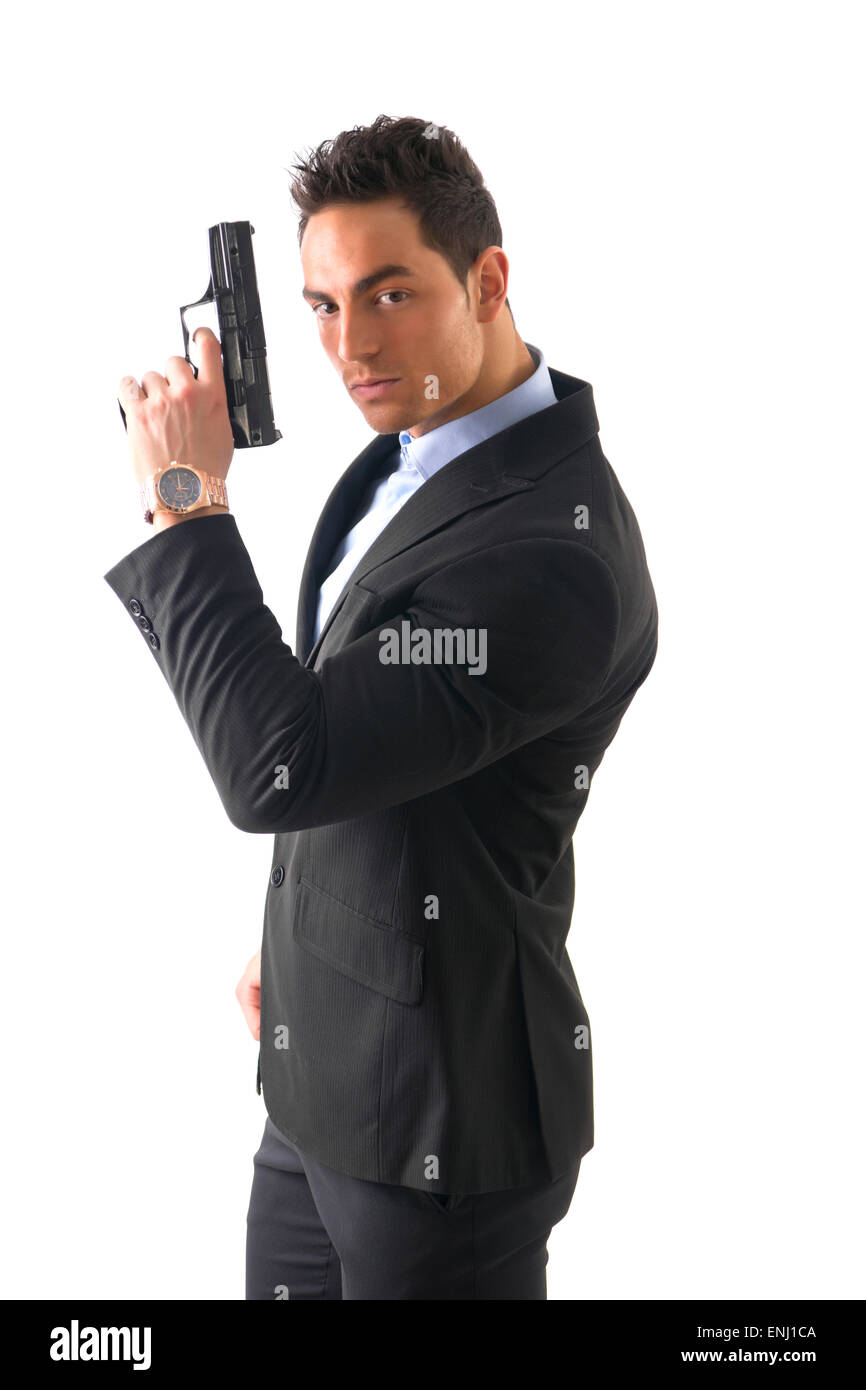 Elegant man with gun, dressed as a spy or secret agent Stock Photo - Alamy