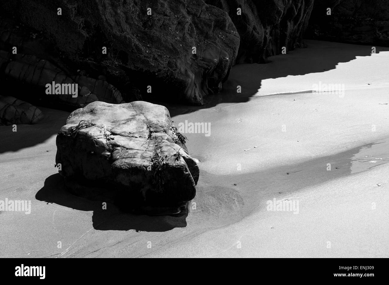Abstract image of sunlight and shadows on the beach at Marloes sands in Pembrokeshire, Wales. Stock Photo
