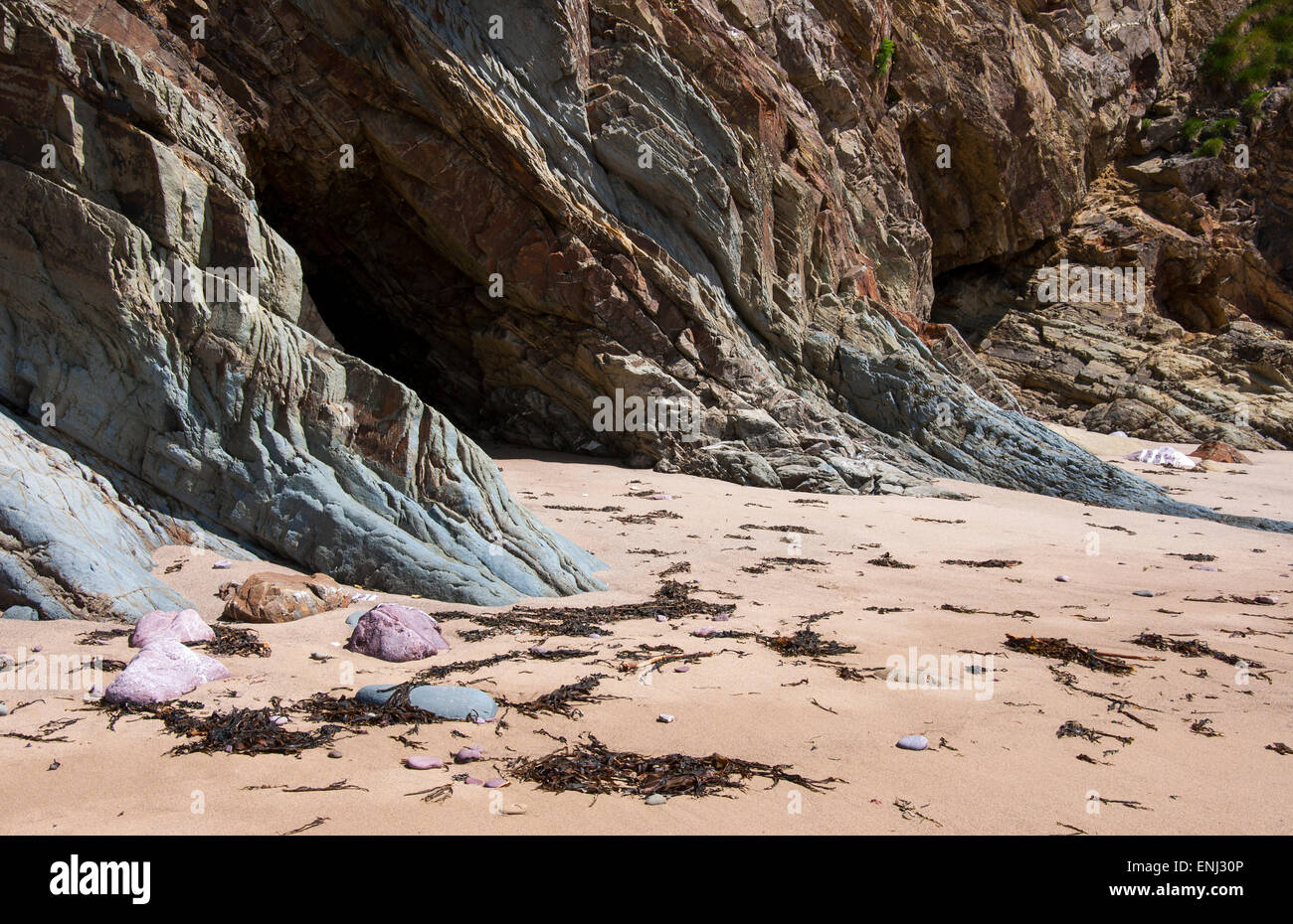 Beautiful warm coloured rocks on a section of beach at Marloes sands in ...