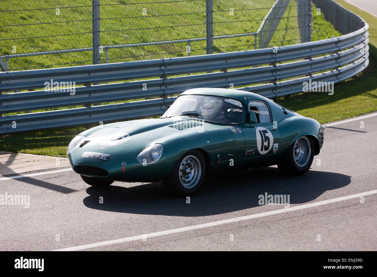 A classic, 1962, historic,  lightweight, low drag, Jaguar E-Type  enters the pit lane, during the Silverstone Classic media Day. Stock Photo