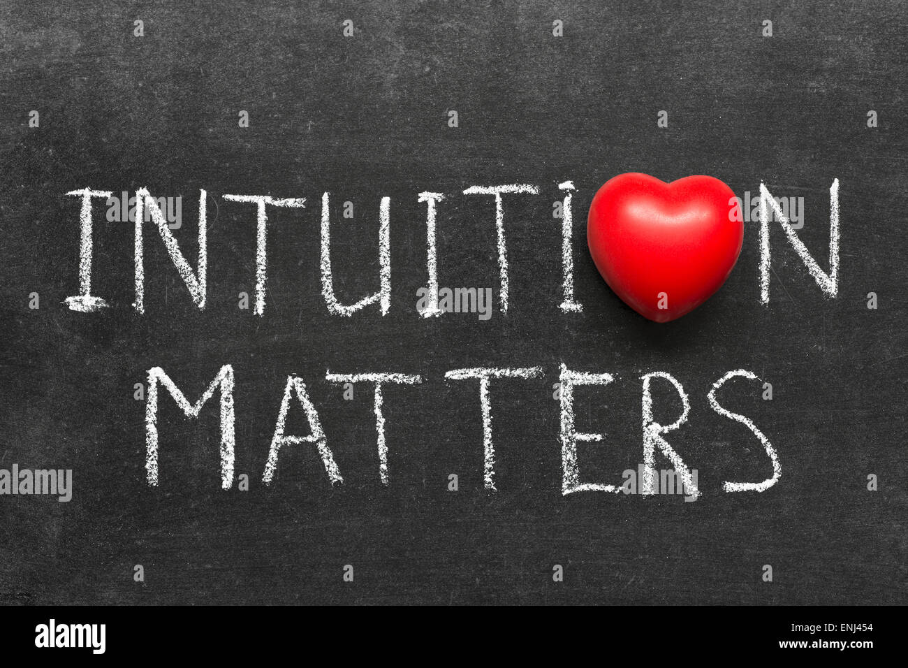 intuition matters phrase handwritten on blackboard with heart symbol instead of O Stock Photo