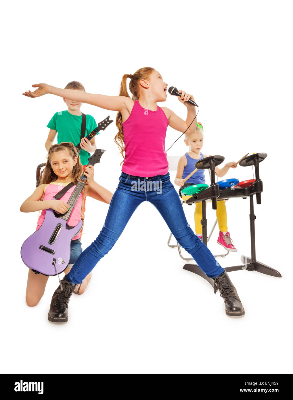 Children play musical instruments and girl sings Stock Photo