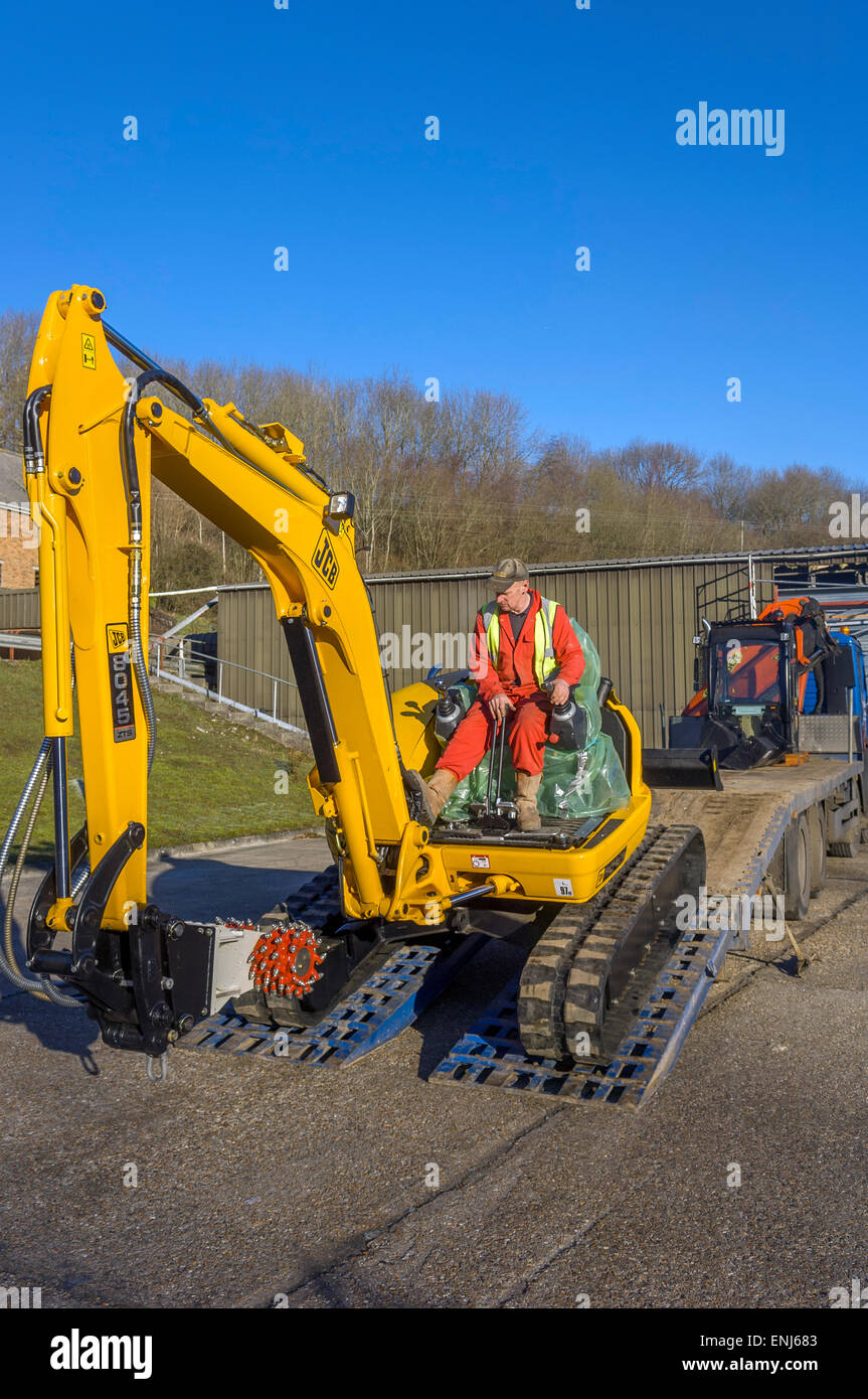 A brand new JCB 8045 mini excavator being delivered on a lorry trailer. UK Stock Photo