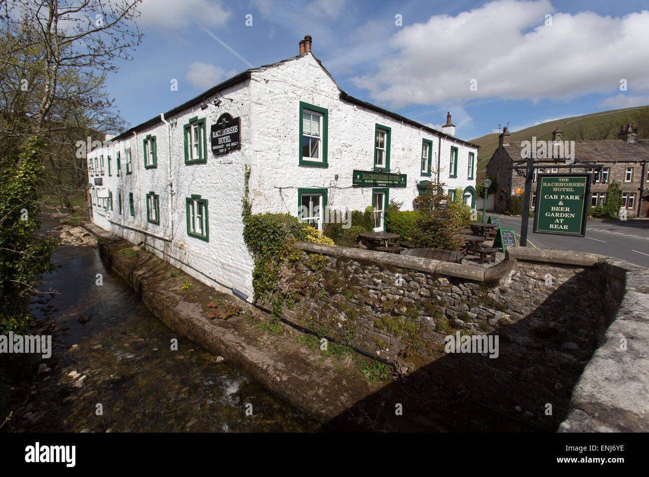 Village of Kettlewell, Yorkshire, England. The 18th century Racehorses Hotel with Kettlewell Beck (stream) in the foreground. Stock Photo