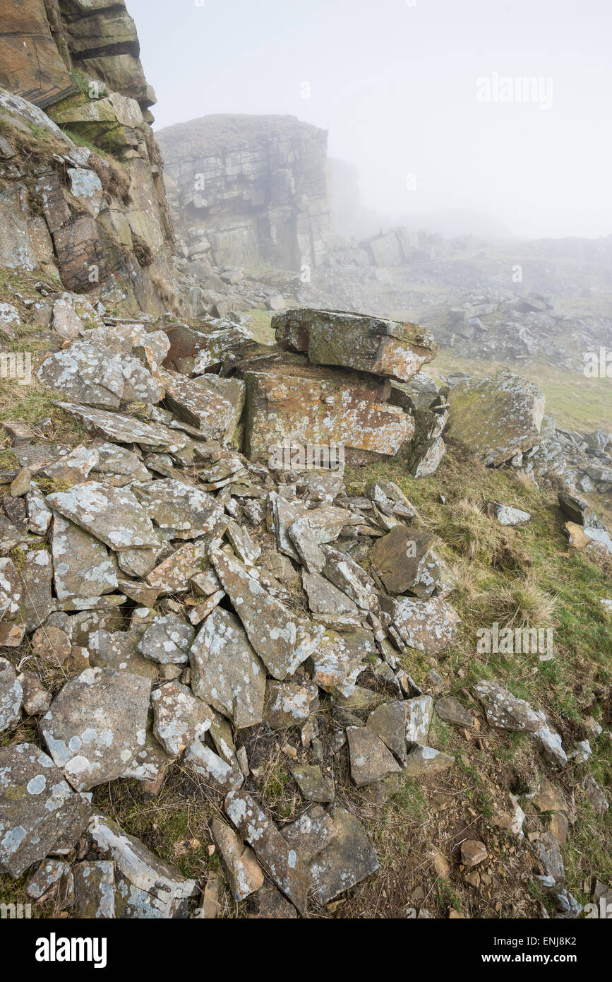 Fallen rocks scatted about at the disused quarry on Cracken edge near Chinley in Derbyshire. Stock Photo