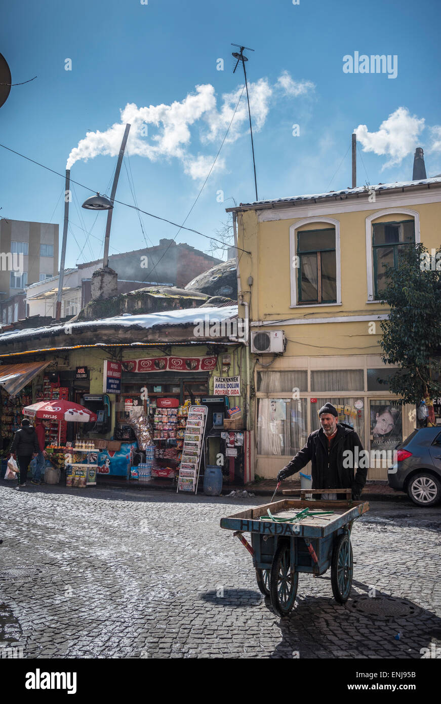 Street scene with  Steam/smoke escaping from stove pipes above the Tahtali Minare hamam in the Balat / Fener neighbourhood of Is Stock Photo