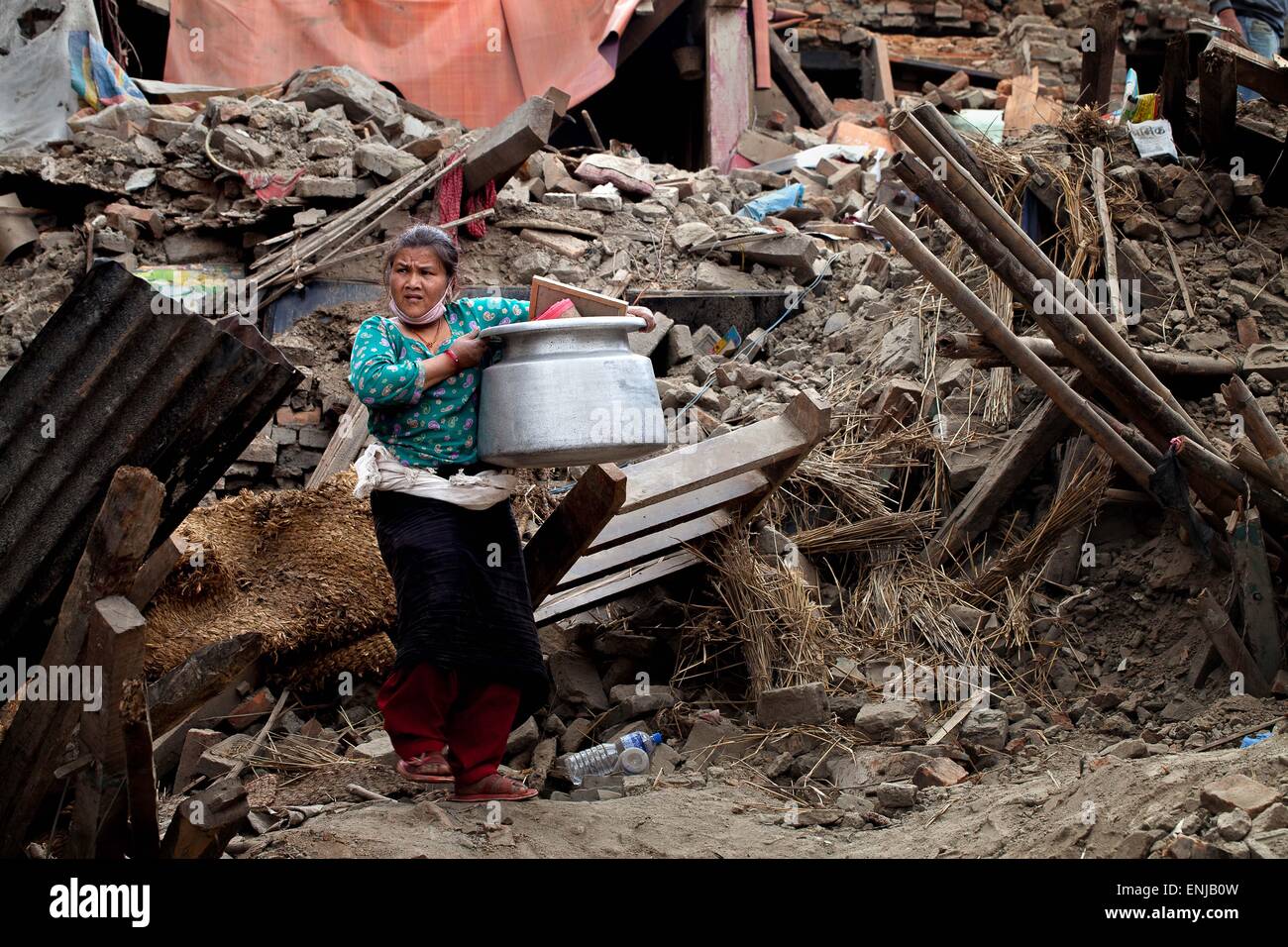 May 1, 2015 - May 1, 2015 - Kathmandu, Nepal- Earthquake victim carry out with their belongings from damage house after following massive earthquake magnitude-7.8 hit the country on 25 April 2015 in Bhaktapur dipstick Kathmandu, Nepal. School of Civil and Environmental Engineering Associate Professor Linlin Ge said the displacement was less than expected, prompting fears the stress that caused the initial earthquake may not have been fully released. ''It should be roughly several meters, '' he said. There are a lot of concerns about what is to come in terms of aftershocks, because the ground d Stock Photo