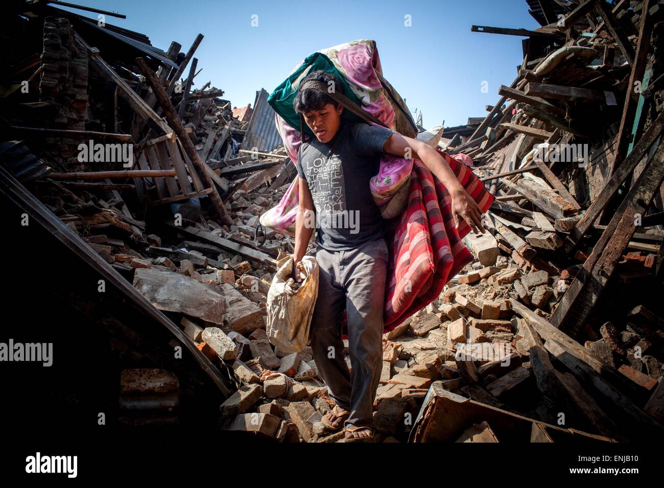 May 1, 2015 - May 1, 2015 - Kathmandu, Nepal- Earthquake victim carry out with their belongings from damage house after following massive earthquake magnitude-7.8 hit the country on 25 April 2015 in Bhaktapur dipstick Kathmandu, Nepal. School of Civil and Environmental Engineering Associate Professor Linlin Ge said the displacement was less than expected, prompting fears the stress that caused the initial earthquake may not have been fully released. ''It should be roughly several meters, '' he said. There are a lot of concerns about what is to come in terms of aftershocks, because the ground d Stock Photo