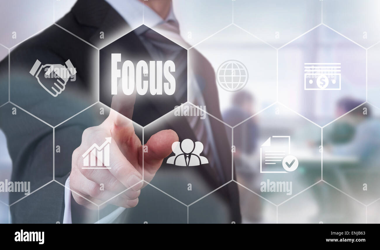 Businessman pressing an Focus concept button. Stock Photo
