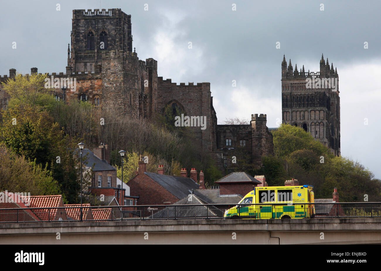 An ambulance driving though Durham with Durham Cathedral and Durham Castle in the background Stock Photo