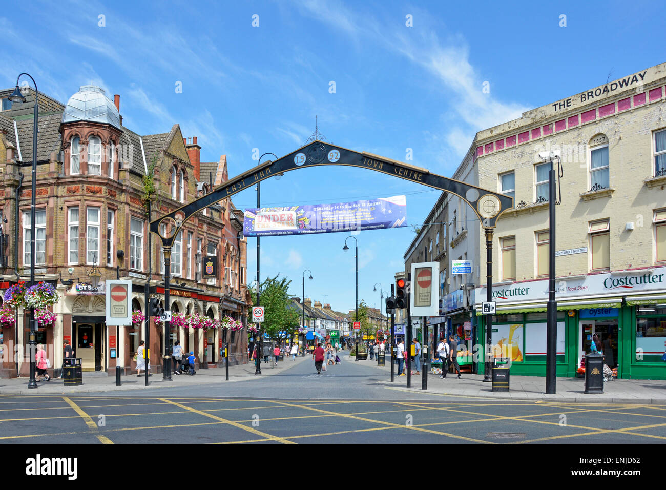 Major road box junction in East Ham with main shopping street High Street North directly ahead restricted entry to vehicles Newham East London UK Stock Photo