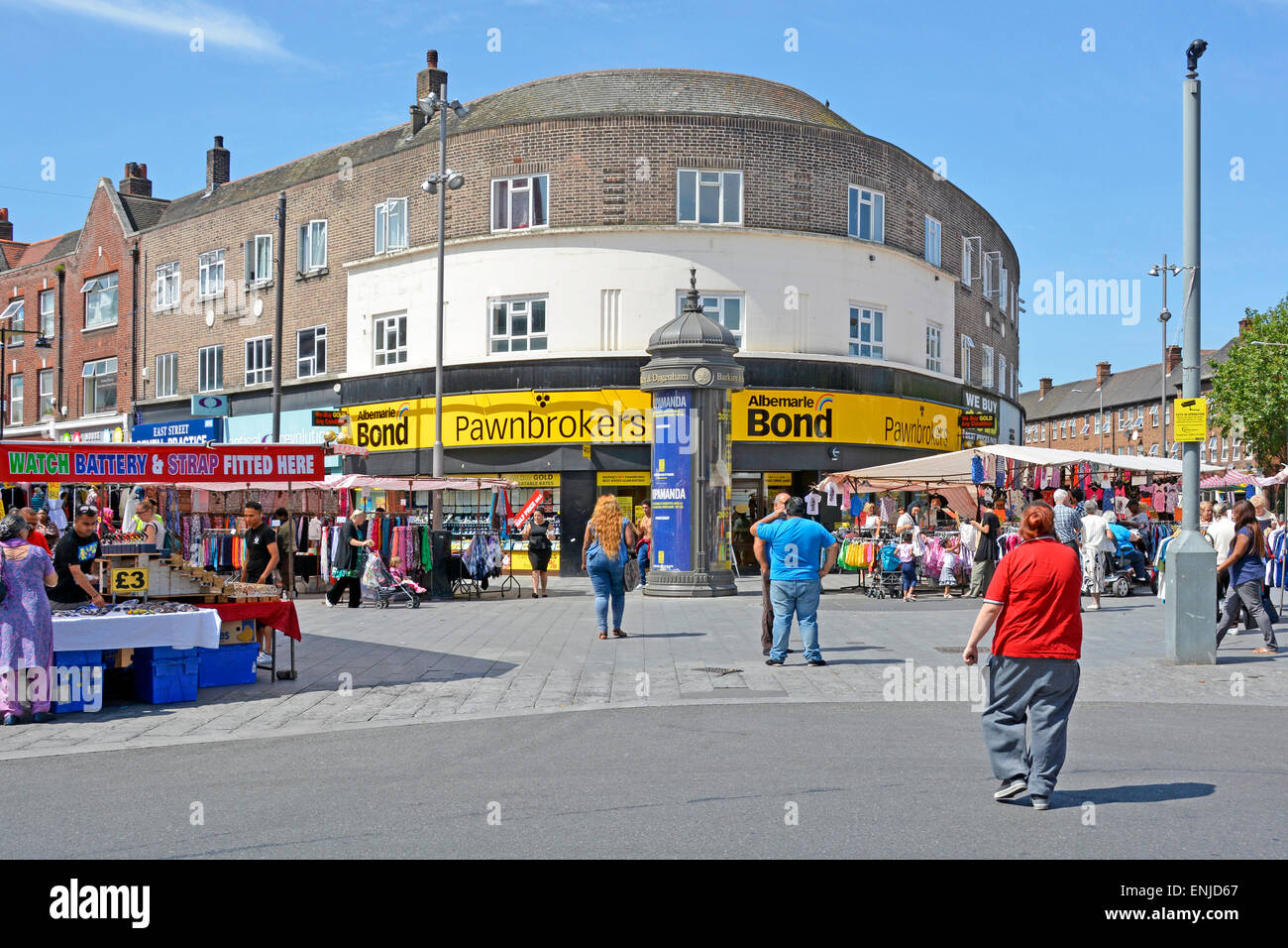 Barking town centre people shoppers in pedestrianised street scene with Albemarle & Bond pawnbroker pawn shop and market stalls East London England UK Stock Photo
