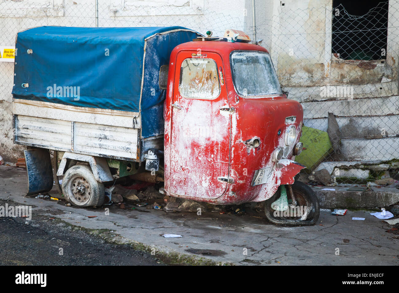 Izmir, Turkey - February 7, 2015: Old red and blue tricycle cargo bike stands on the street of Izmir. This is traditional small Stock Photo