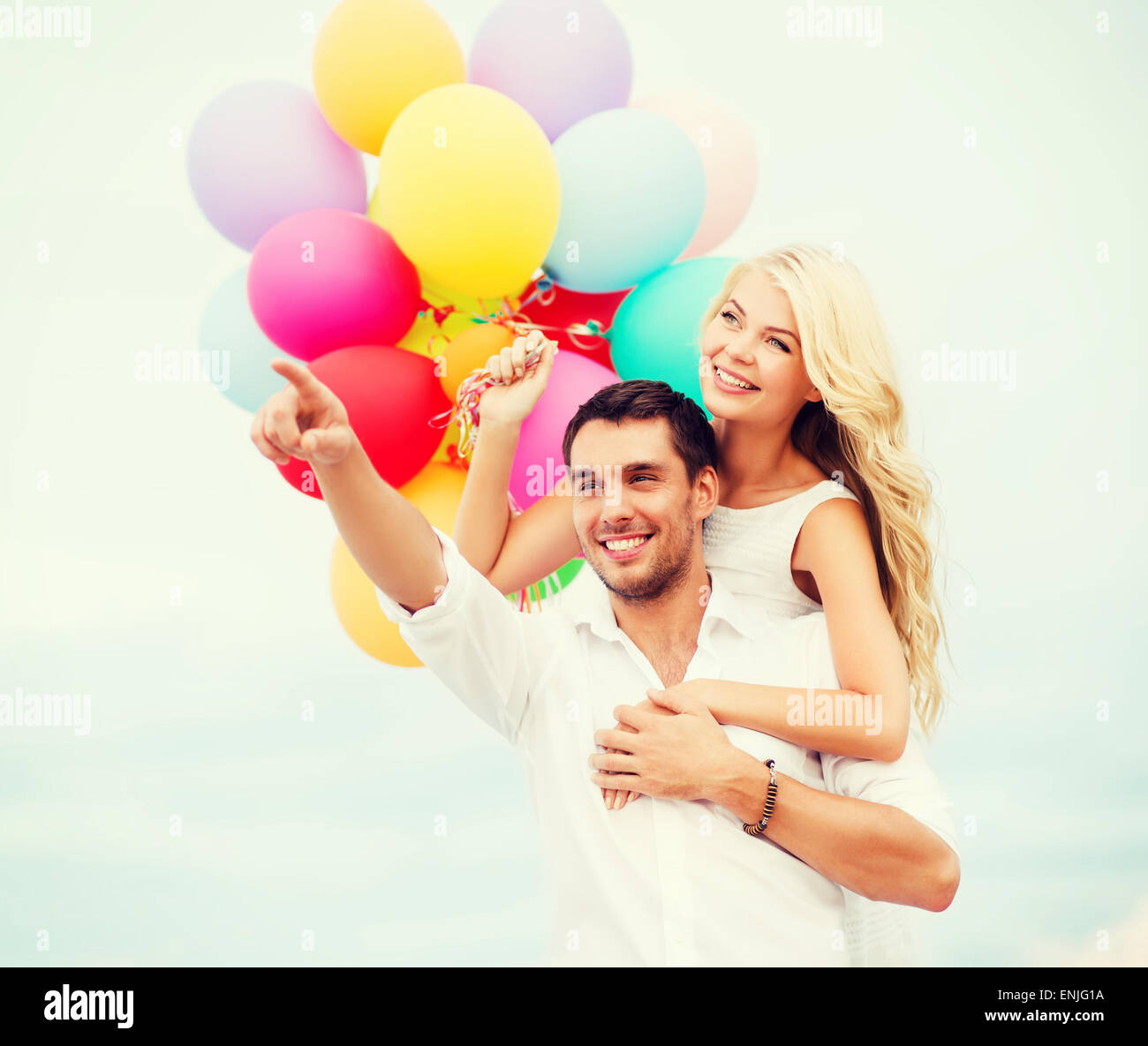 couple with colorful balloons at sea side Stock Photo - Alamy