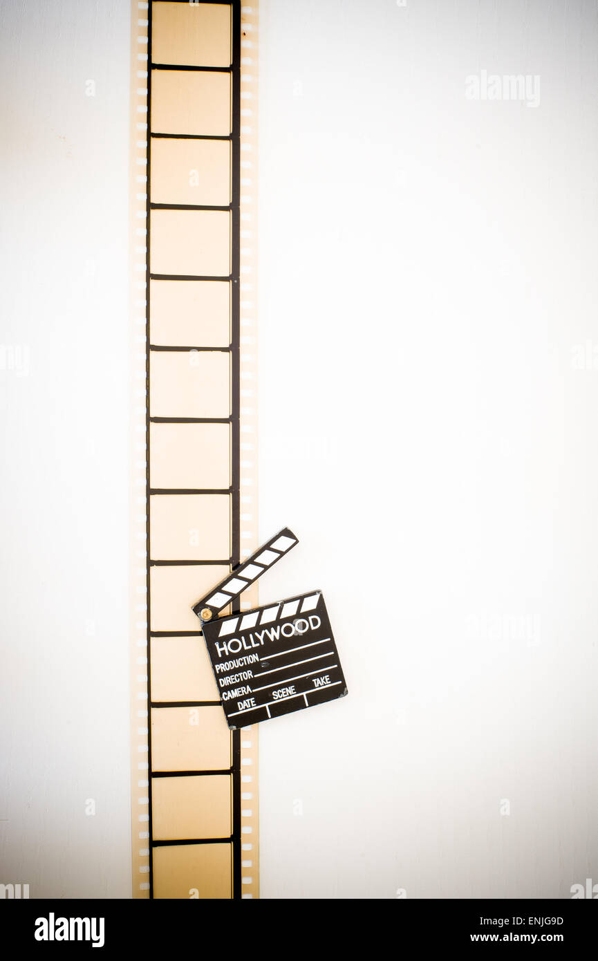 35mm movie filmstrip blank frames reel with clapper board vintage color effect vertical Stock Photo