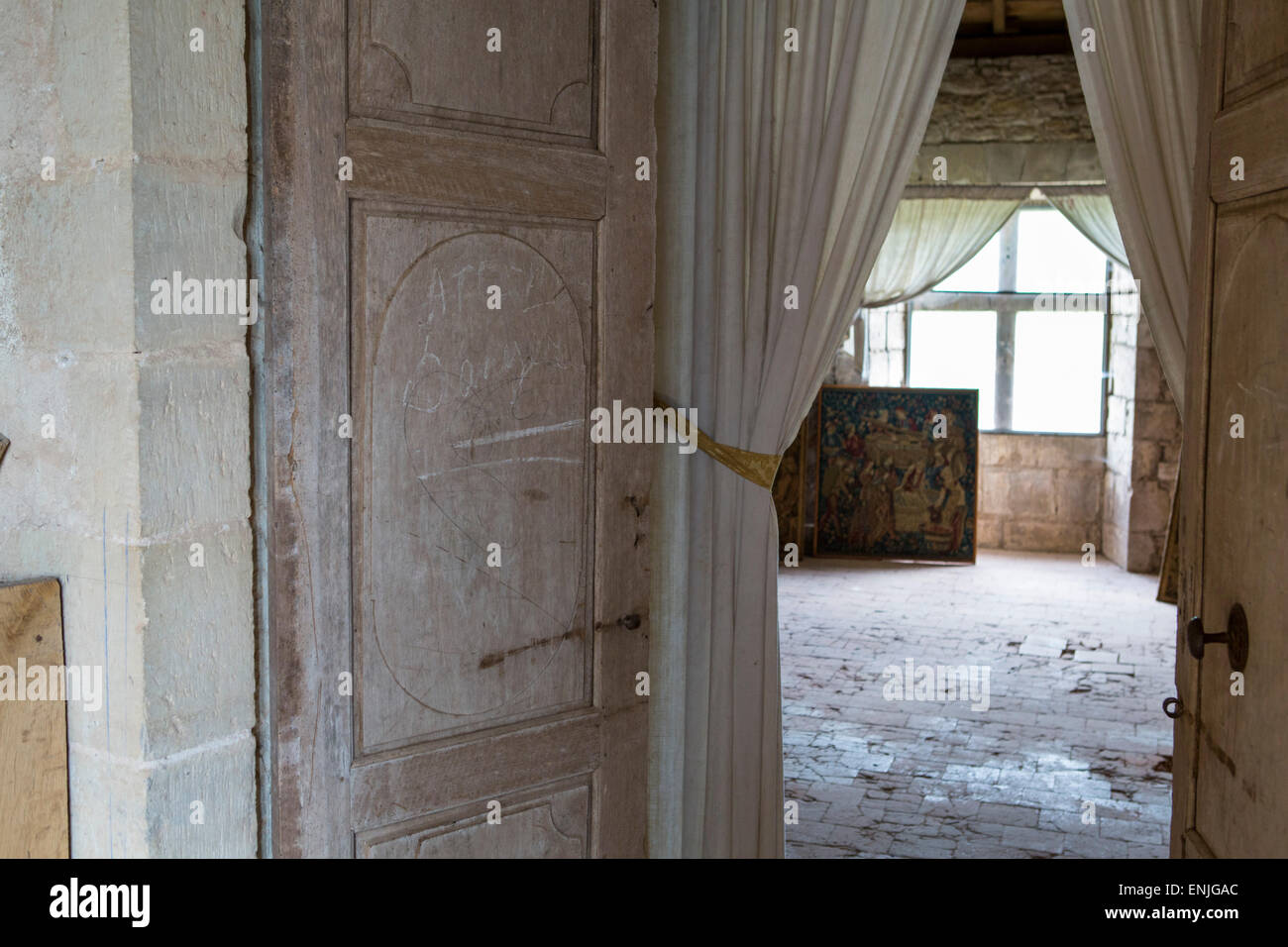 Room at medieval castle Bruniquel with doors, tapestry and curtains,Tarn et Garonne, Midi-Pyrenees, France Stock Photo