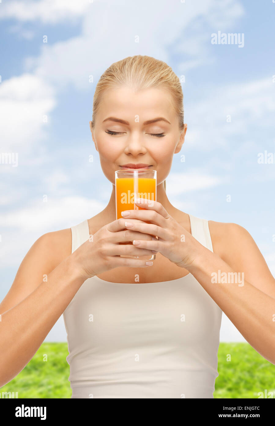 young woman drinking orange juice Stock Photo Alamy