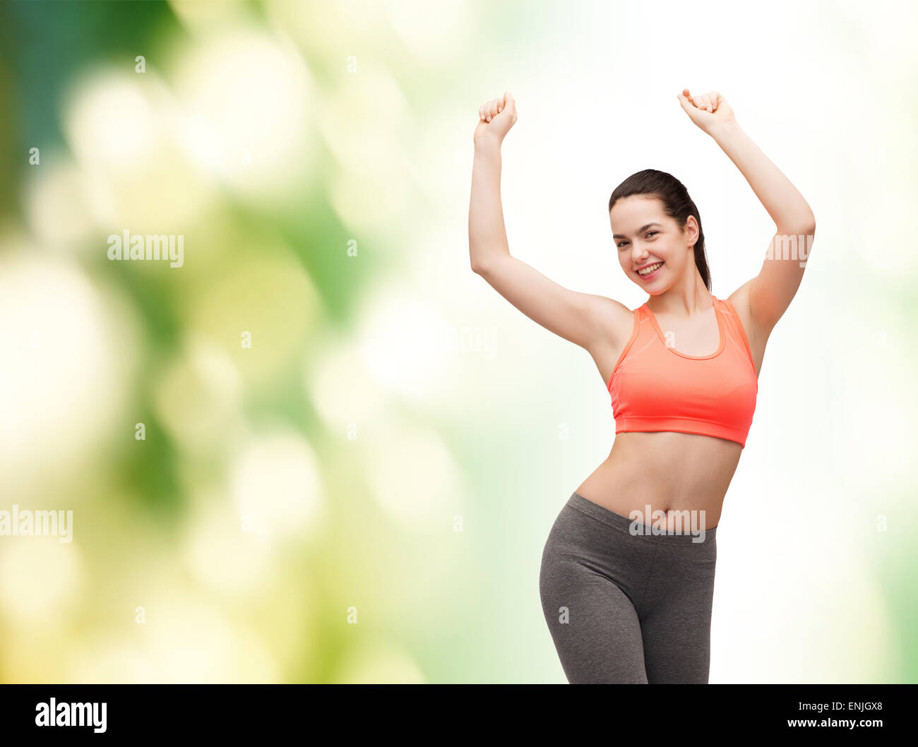 smiling teenage girl in sportswear dancing Stock Photo