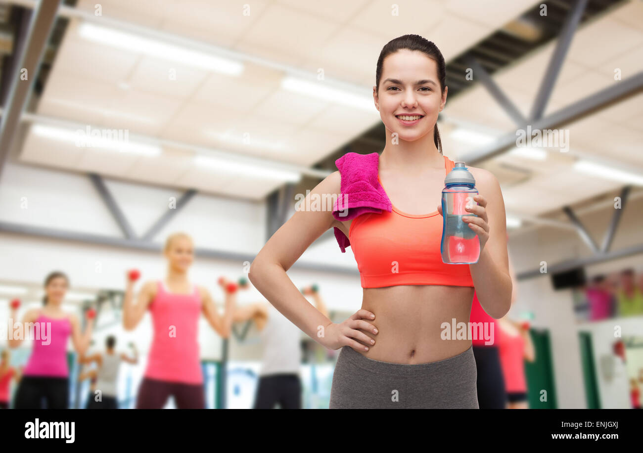 sporty woman with towel and water bottle Stock Photo - Alamy