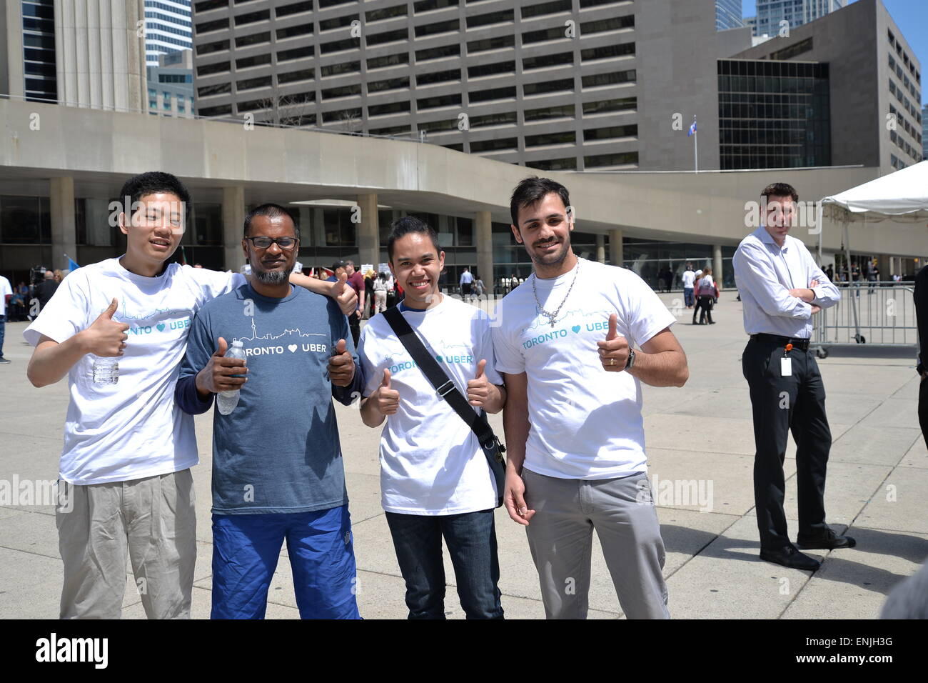 Toronto, Canada. 6th May, 2015. Nathan Phillips Square was the scene for the gathering of 100+ Uber supporters, organized in a semi-circle, chanting “Make Uber here to stay! Don’t let it go away!” and other various pro-Uber statements. Credit:  NISARGMEDIA/Alamy Live News Stock Photo