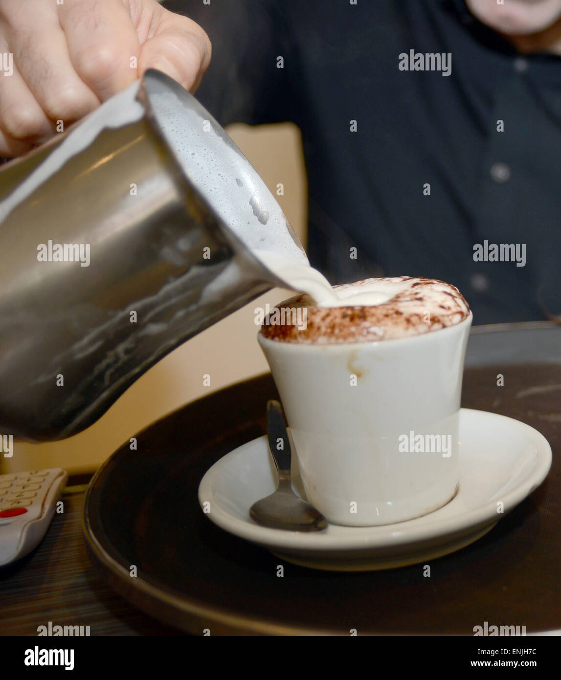 frothing the milk which came from a cow 4 hours before Stock Photo Alamy