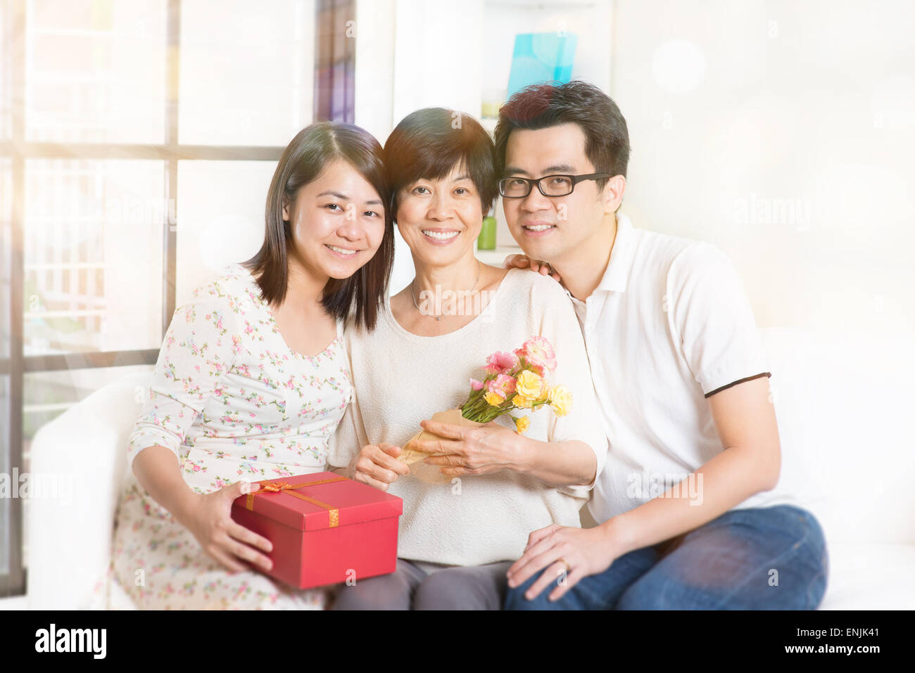 Happy Asian Man Giving Gift Box To His Mother For Mother's Day Celebration.  Stock Photo, Picture and Royalty Free Image. Image 128548402.
