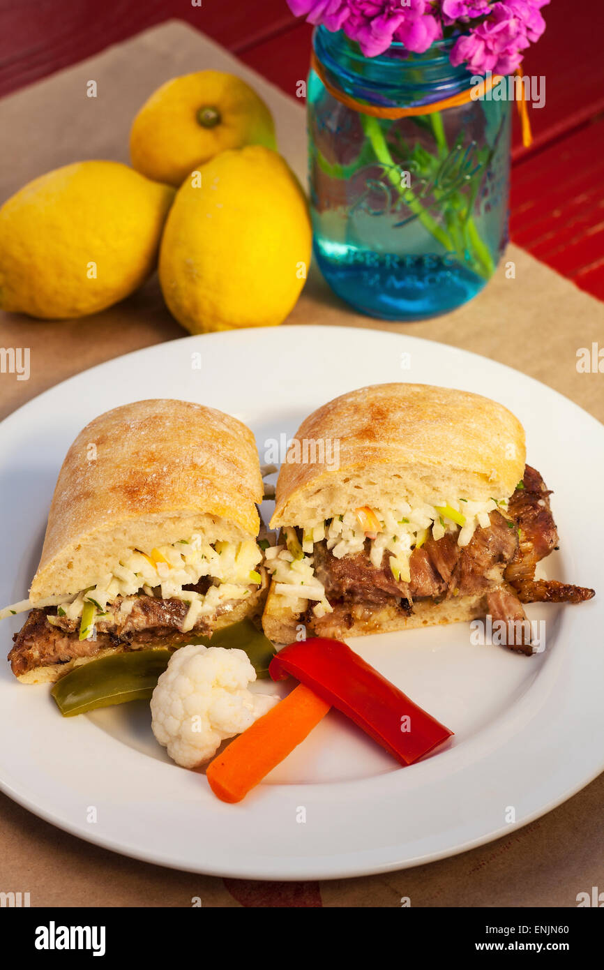 crispy rotisserie pork sandwich with pickled vegetables, Bell Street Farm deli, Los Alamos, California Stock Photo