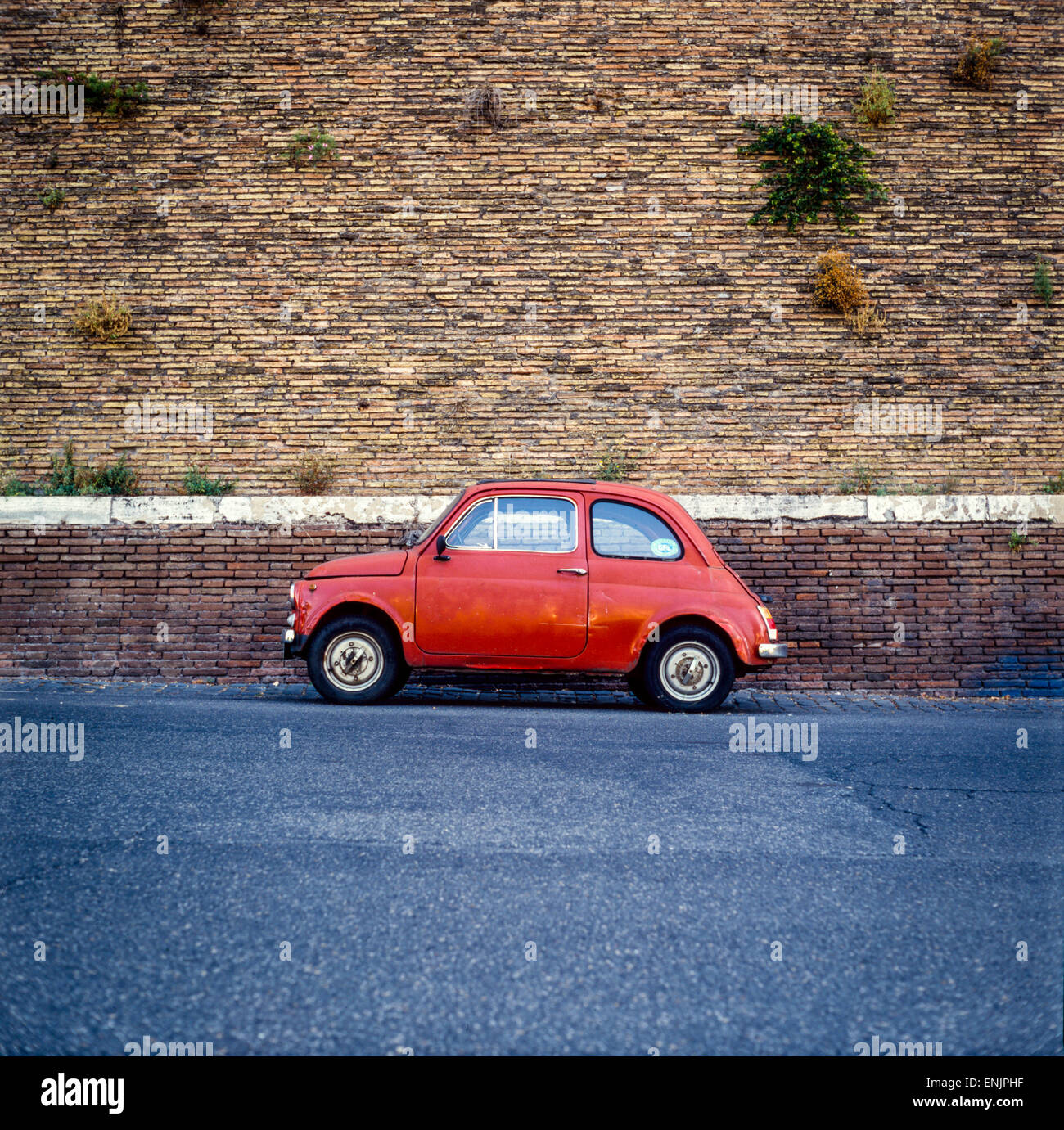 Fiat 500 Italy Rome, red car parked at a brick wall Rome Italy Stock ...
