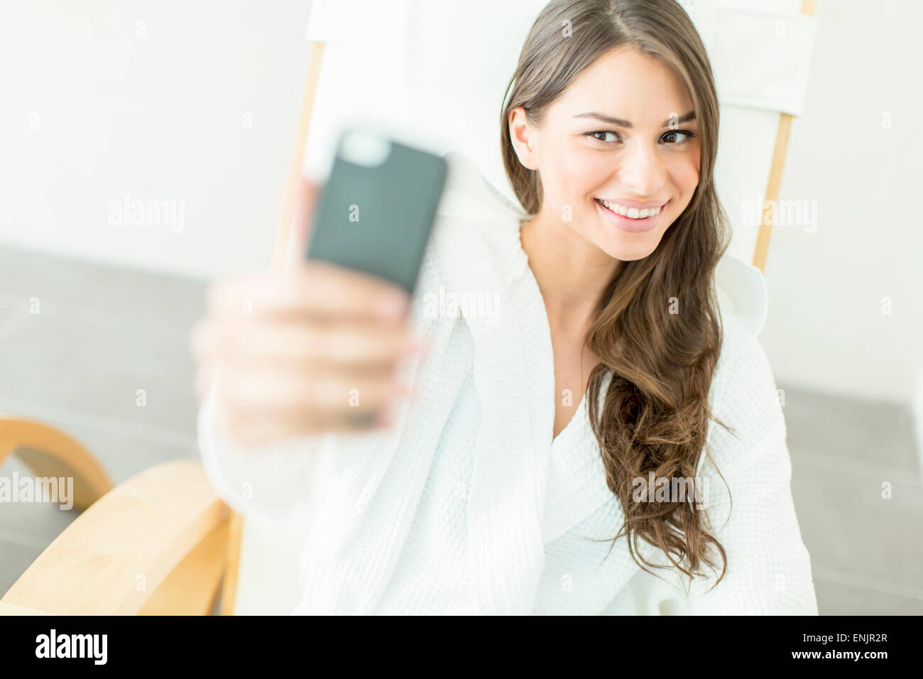 Young woman taking selfie with mobile phone in spa center Stock Photo ...