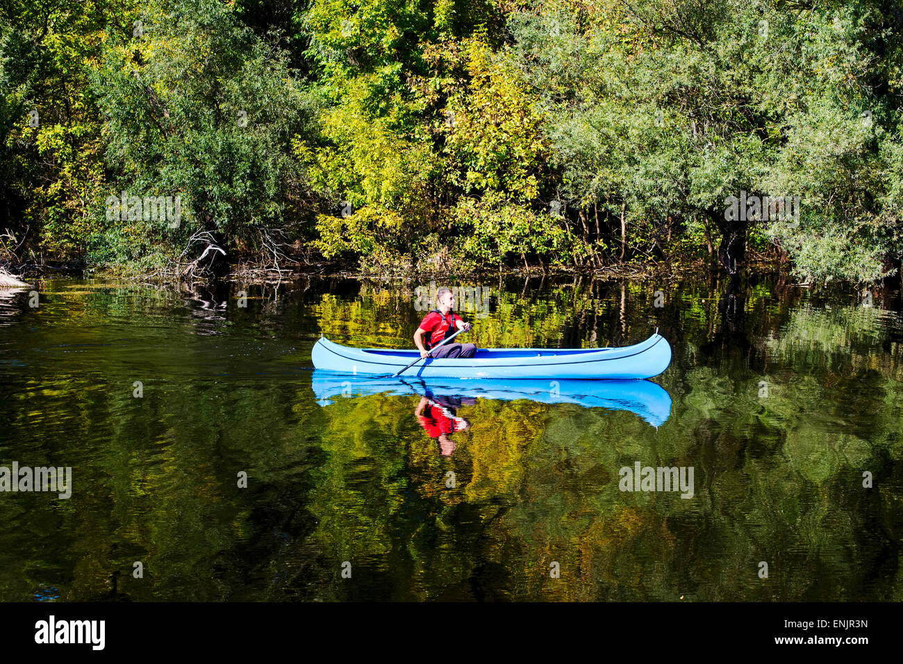 Young man in canoe Stock Photo - Alamy