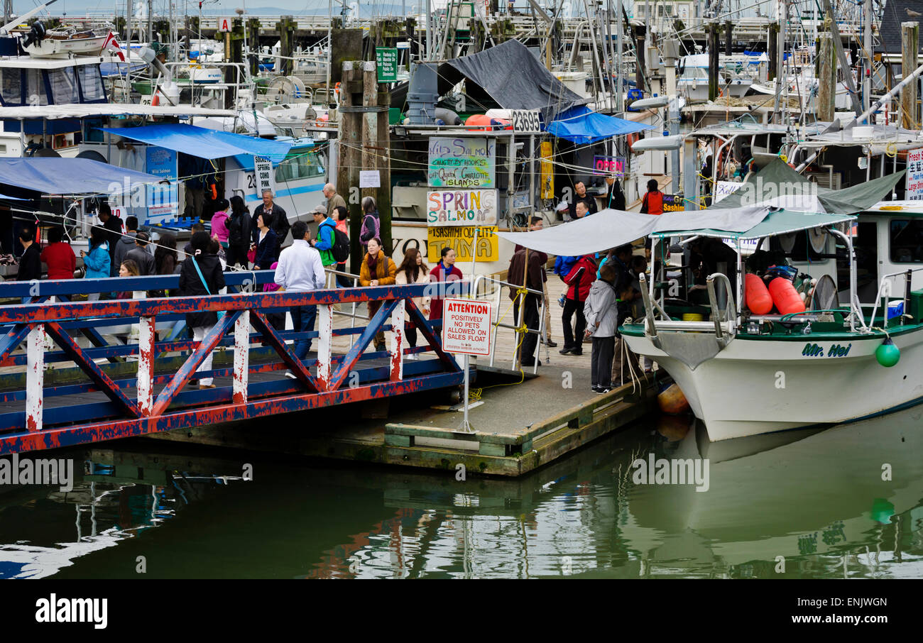 Buyers and sellers of fresh seafood off the fishing boats in Steveston Village, British Columbia, Canada.  At Fisherman's Wharf. Stock Photo