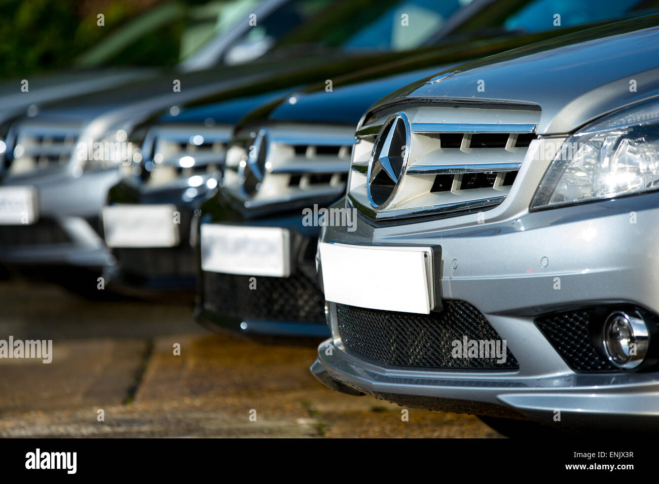 A row of Mercedes Benz cars lined up in a car showroom in England, UK ...