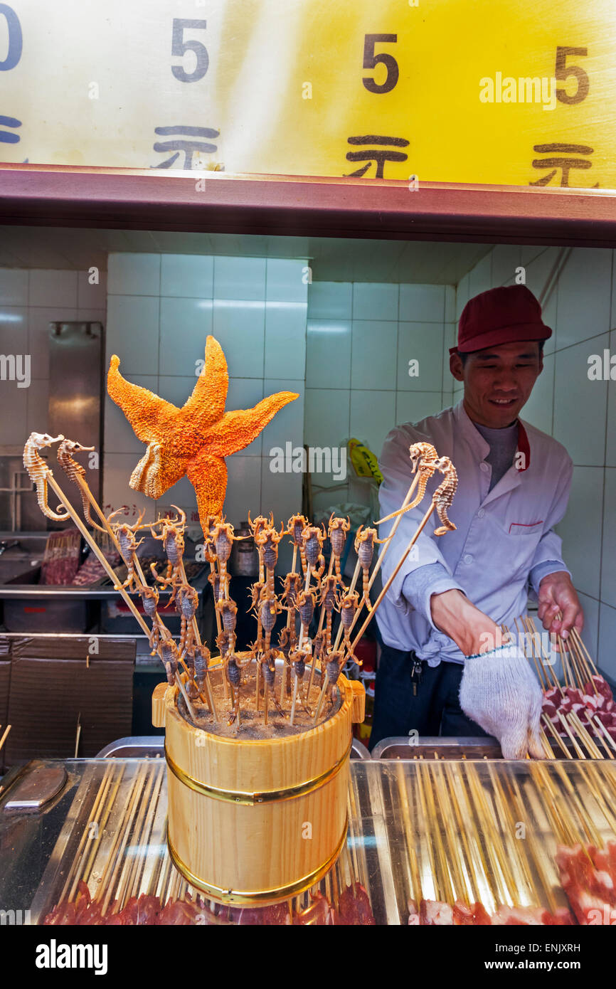 Scorpions, seahorses, starfish and other delicacies on skewers for sale at Wangfujing Street night market, Beijing, China, Asia Stock Photo