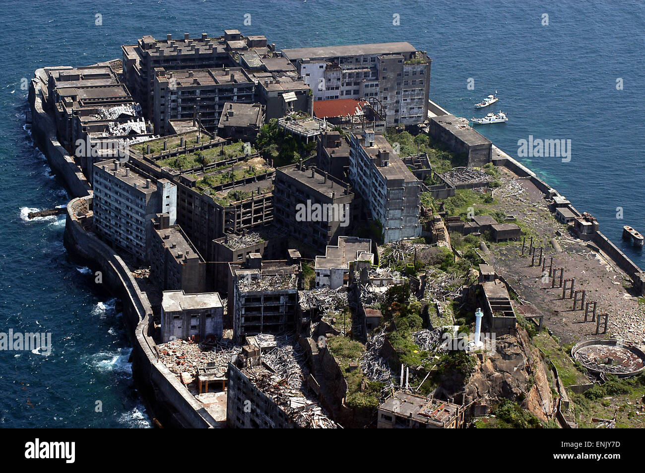 Hashima, Nagasaki, Japan. Also known as Gunkanjima (battleship island), it used to have coal mines and housed over 4,000 inhabitants. After it was abandoned in the mid 20th century the town turned into a ghost town. Stock Photo