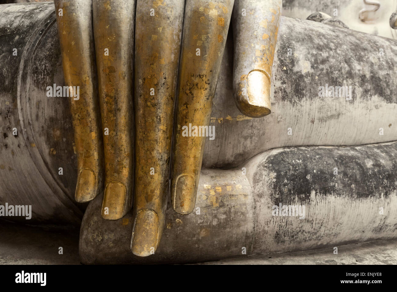 Hand of the Phra Achana Buddha figure, covered in gold leaf, Wat Si Chum, Sukhothai Historical Park, Thailand Stock Photo
